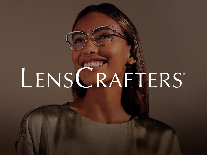 LensCrafters logo over an image of a pretty black woman wearing glasses and smiling.