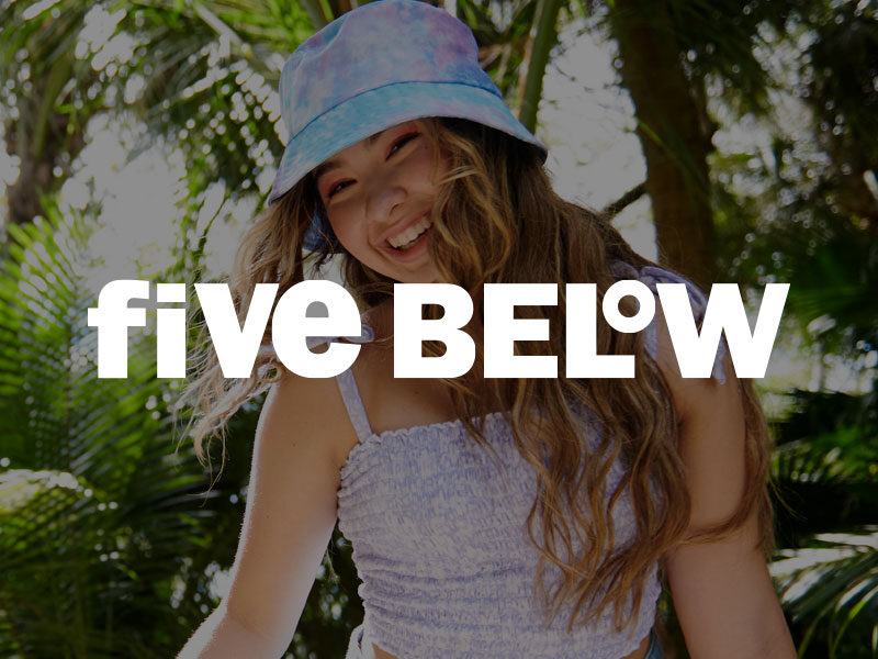 Five Below logo over an image of a Young girl wearing a tie dyed bucket hat smiling with palm trees in the background.