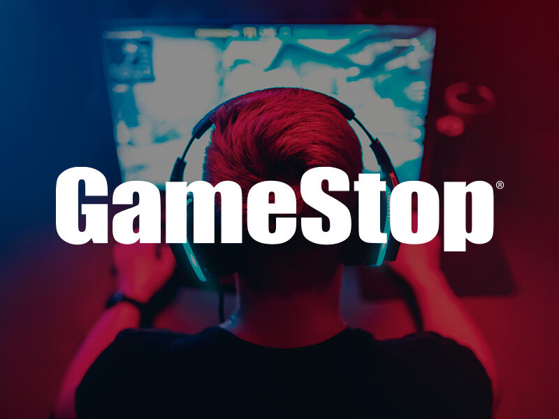 GameStop logo over an image of a guy wearing headphones playing computer games.