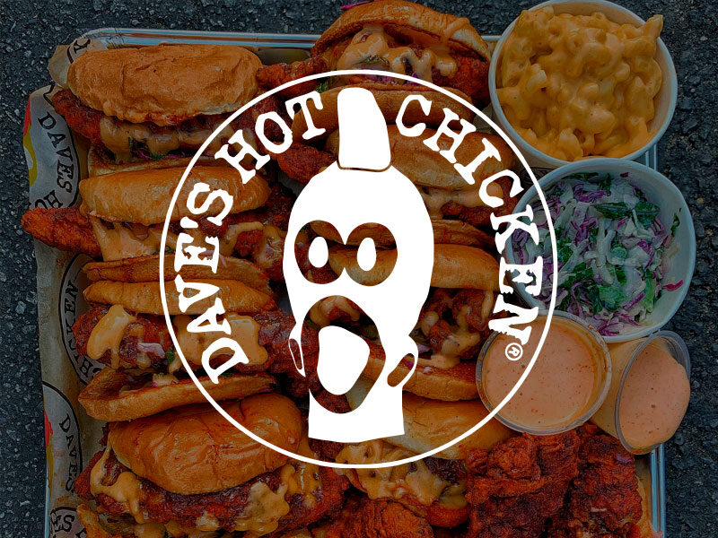 Dave's Hot Chicken logo over an image of Large metal tray with a bunch of hot chicken sandwiched and fries with dipping sauces from Dave's Hot Chicken.